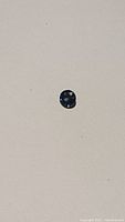 Faceted sapphire on white background showing overall shape and color