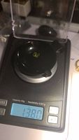 Photo of the peridot gemstone on a scale showing weight 1.38 carats.