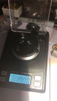Two natural sky blue topaz gemstones being weighed on a scale showing combined weight of 1.90 carats.