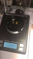 Two small opals on a digital scale showing a combined weight of 1.405 carats.