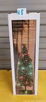 Boxed 14 inch glitter Christmas tree showing picture and description of the tree on the packaging.