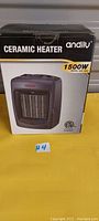Front of the box showing the andily ceramic heater with 1500W power printed on packaging.