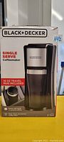 Front box panel of Black and Decker Single Serve Coffeemaker showing product image and key features including 16oz travel mug included.