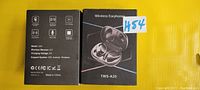 Box front and back showing TWS A20 wireless earbud product, specifications including Bluetooth 5.2, wireless stereo, charging voltage 5V.