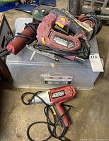 View of all four Chicago Electric power tools stacked, showing cords and detail of a jigsaw and a heat gun.