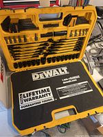 Open chest showing majority of tools arranged including bit driver handle, bits, wrenches, sockets.