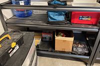 Full view of the steel shelving unit loaded with various storage items to show shelf surfaces and structure.