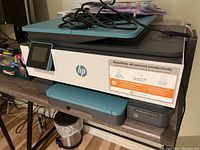Front view of HP OfficeJet Pro 8028e printer showing touchscreen panel, front logo, and productivity information sticker.