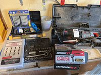 Overview of lot showing Porter Cable reciprocating saw, socket set, precision screwdrivers, and plastic fastener kit