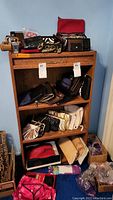 Wide view showing shelves filled with various purses, clutches, wallets, and boxes beneath containing other items like pajamas and boots.