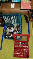Open blue fabric jewelry case showing seed bead necklaces and faux pearl necklaces in lid