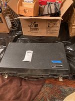 Closed textured black carrying case with latches, handle, label reading ‘Solid State Tube Tester 747’ and inventory sticker