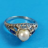 Front view of ring showing filigree band and central pearl