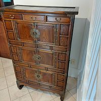 Front view of closed cupboard showing three drawers at top and three door panels below