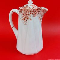 Front view of lidded pot showing floral transfer around shoulder and body faceting