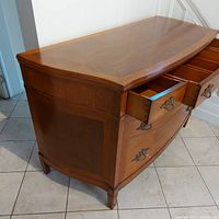 Upper half angle view with two top drawers open showing bowfront shape and interior