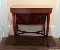 Front view of closed top with slatted front panel and tapered legs