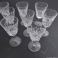 Group of eight Waterford Lismore crystal wine goblets displayed together showing the signature cut pattern and overall shape.
