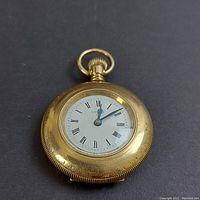 Front view showing half hunter case with visible enamel dial and blued steel hands