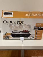 Front view of boxed Crock-Pot Duo Cook & Serve slow cooker showing name, image, and features of the product.