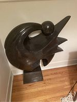 Front view of polished abstract sculpture on rectangular base