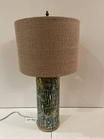 Full view of the lamp showing mosaic base and burlap shade.