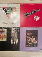 8 vinyl LP records laid out, showing cover art of Bronski Beat, Barenaked Ladies, Hank Williams, and Prince albums.