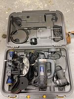 Mastercraft corded router and attachments inside molded plastic carrying case, nib and sanding pads visible