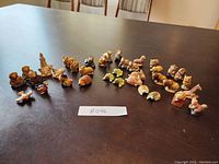 Overview photo showing entire collection of Red Rose Tea animal figurines arranged on a table to display quantity and variety.