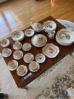 Overview of cups, saucers, plates, bowls, teapot, tureen, creamer and platter displayed on table