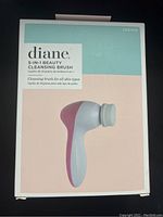 Photo of the sealed box for the Diane 5-in-1 Beauty Cleansing Brush showing front packaging with product image and details.