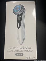 Photo of the unopened facial skin care massager box showing front with device image, model W-618 and text.
