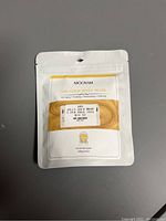 Image of new unopened Mooyam 24K Gold Jelly Mask pouch, 100g size.