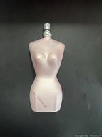 Front view of Jean Paul Gaultier Classique perfume bottle shaped like a female torso in pink metallic color.