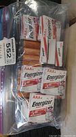 Plastic bag containing multiple Energizer Max AAA4 battery packs and one AA4 battery pack in original packaging.