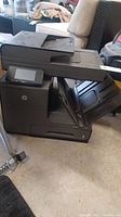 Front side view of HP OfficeJet Pro x576dw printer showing its design and physical condition.