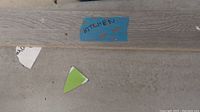 Tile with wood plank texture labeled 'Kitchen' on blue tape
