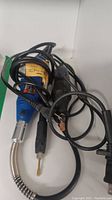 Photo showing both tools tangled cords and parts visually.