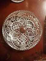 Top view showing full round cut crystal dish with detailed decorative patterns and scalloped zig zag edging