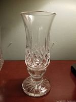 Single Waterford hurricane candle holder showing diamond cut pattern on lower half and clear flared top.