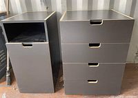Front view of two grey cabinets side by side; left cabinet has one drawer and open lower door, right cabinet has four drawers.