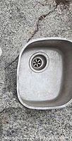 Top view of stainless steel bar sink showing basin shape and drain detail