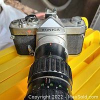 Front angled view of Konica T3 camera with 80-200mm telephoto zoom lens attached showing body details and lens markings.