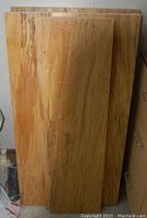 Photo of five spalted maple wood boards standing upright, showing their natural wood grain and spalting patterns.
