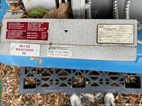 Close-up of pump plate showing Rietschle brand, type, serial, and oil type information labels.