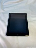 Front view of Apple iPad 1st generation showing black screen and home button