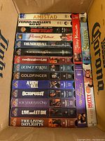 Top view of the VHS collection showing a variety of James Bond movies and other titles in original VHS cases.