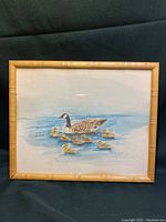 Full view of framed duckling print showing entire artwork and bamboo-like frame.