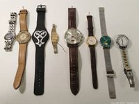 Full lot overview showing all eight watches in a row arranged by strap type and color