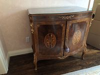 Front view of marquetry buffet cabinet with fitted glass top and floral inlaid panels